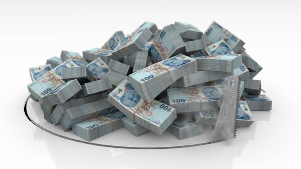 istock Turkish banknotes falling through a hole cut on the floor with a saw 1492640936