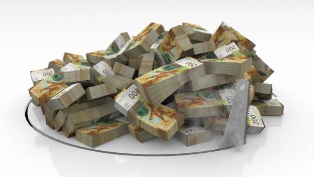 istock Swiss banknotes falling through a hole cut on the floor with a saw 1492641604
