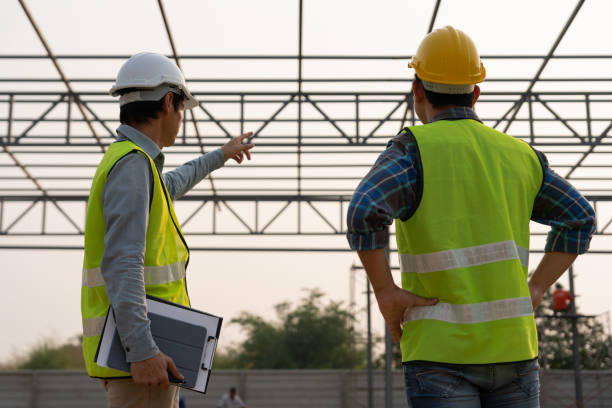 istock inspector or engineer is inspecting construction and quality assurance new factory using a checklist. Engineers or architects or contactor work to build the factory before handing it over to the homeowner 1492642939
