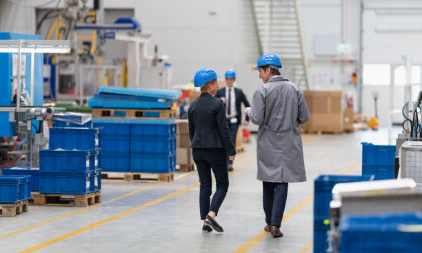 istock Two Engineers Walking Through An Automated Factory And Talking About Working Process 1492642987