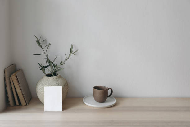 istock Moody wedding stationery. Vertical blank greeting card, invitation. Old vase with olive branches and books on wooden table. Summer Mediterranean design. Elegant working space, home office. No people. 1492643159