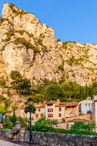 View of the old town of Moustiers-Sainte-Marie, a small town perched on the ridge of a mountain, in the middle of two rocky escarpments