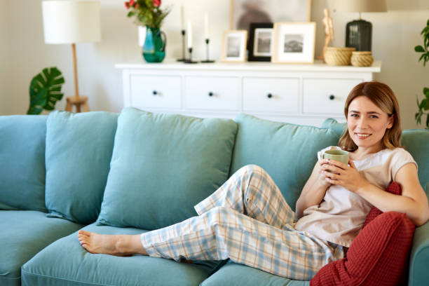 istock An attractive young woman relaxing at home drinking coffee 1492644303