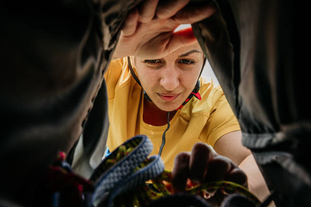 Woman preparing  backpack for a climbing stock photo