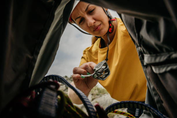 Woman preparing  backpack for a climbing stock photo