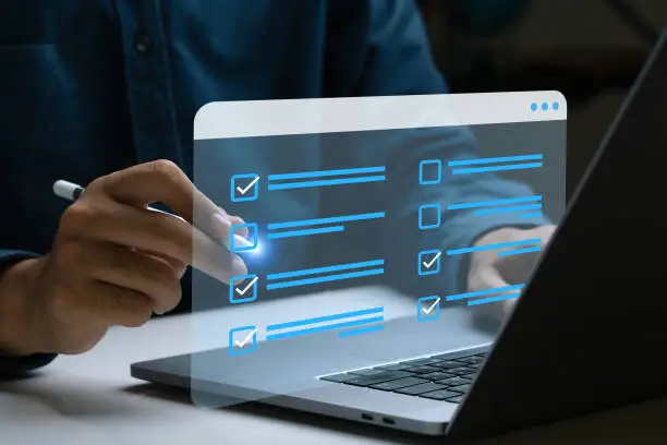 Survey form concept. Businessman using laptops do online checklist surveys, Questionnaire with checkboxes fill survey forms online and answer questions test. Customer Experiences and satisfaction.