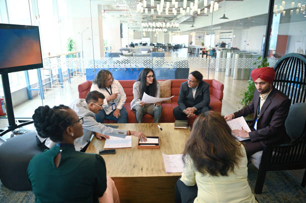istock Diverse group of engineers brainstorming together in a meeting room 1492647805