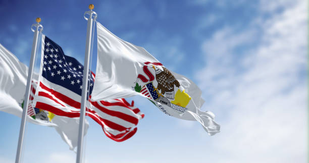 istock Illinois and US flags waving in the wind on a clear day 1492648202