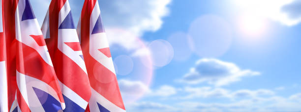 uk flags on the sky background. great britain holiday concept. - british flag freedom photography english flag imagens e fotografias de stock