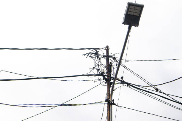 electric pole with messy wires isolated on white background.