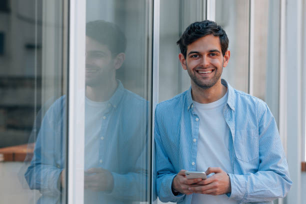 istock young man on the street with mobile phone 1492650769