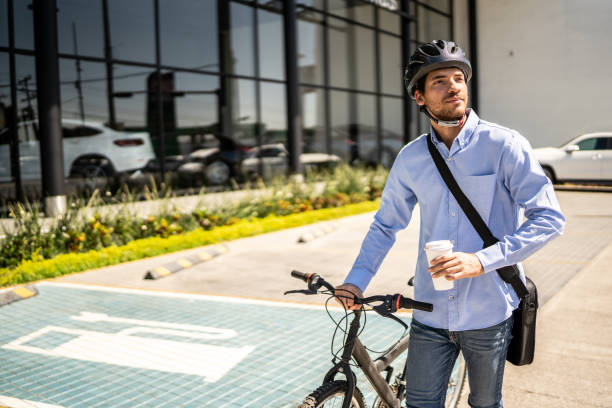 istock Young man walking with bicycle looking around outdoors 1492651633