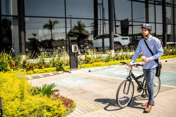 istock Young man walking with bicycle outdoors 1492651682