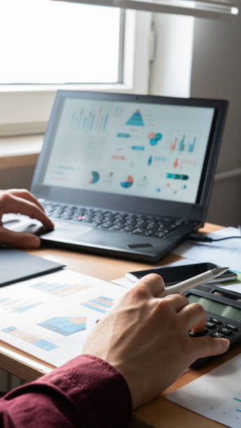istock Close-up Businessman using calculator while working with financial reports at office 1492652665