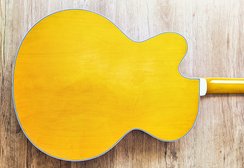 Gold guitar body against white background