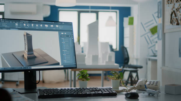 istock Close up of 3d building model on computer screen in empty office for architectural design 1492653615