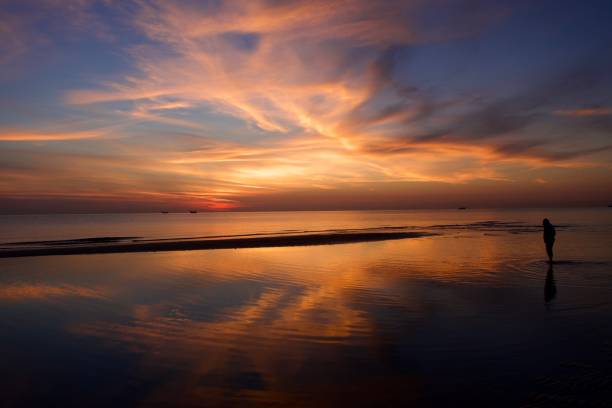 istock Boy walking in the sea during the sunrise 1492654254