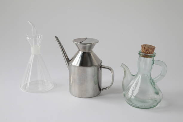 Three containers from different eras in different materials for cooking oils