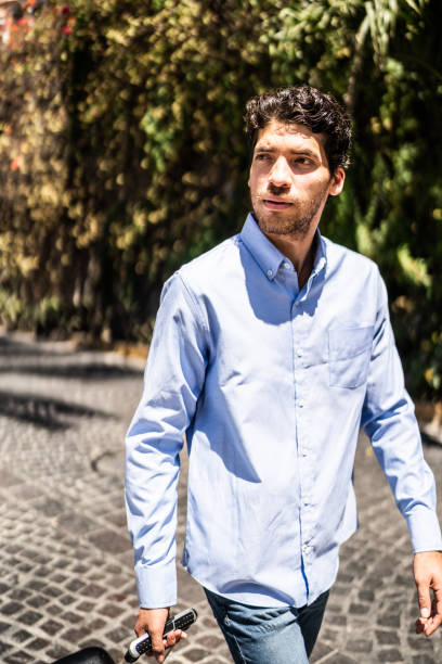 istock Young man walking with luggage outdoors 1492656892