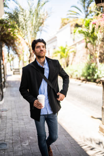 istock Young man walking outdoors 1492656923