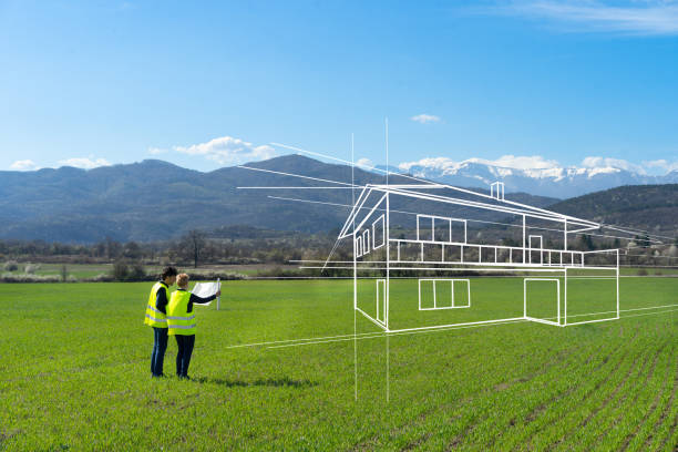 Line drawing of house with two people holding blueprints