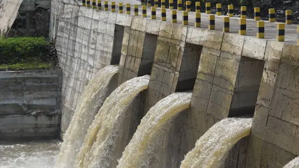 River water flows through the dam