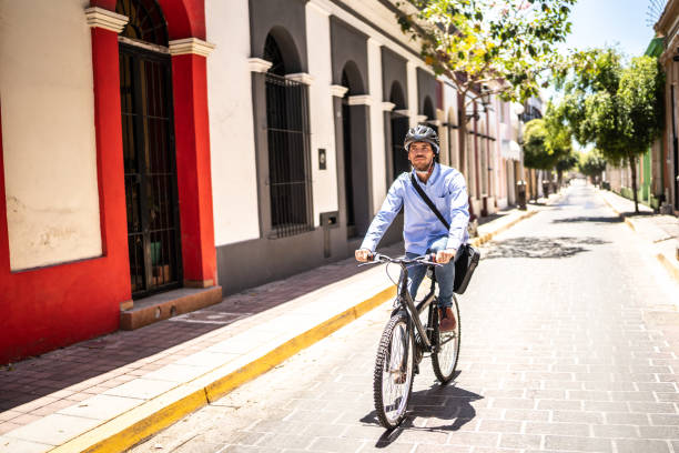 istock Young man riding bicycle wearing protecting helmet outdoors 1492658477