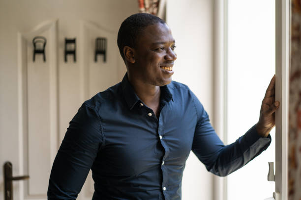 istock Smiling man looking out towards a garden 1492659465