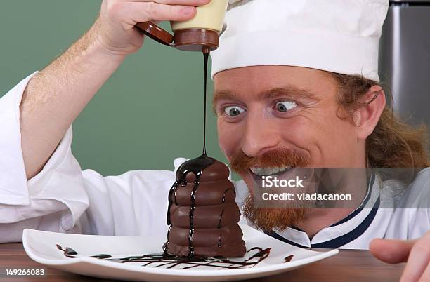 Funny Young Chef Added Chocolate Sauce At Piece Of Cake Stock Photo - Download Image Now