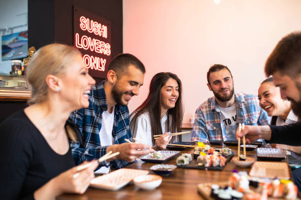 istock Friends having fun eating sushi 1492661236