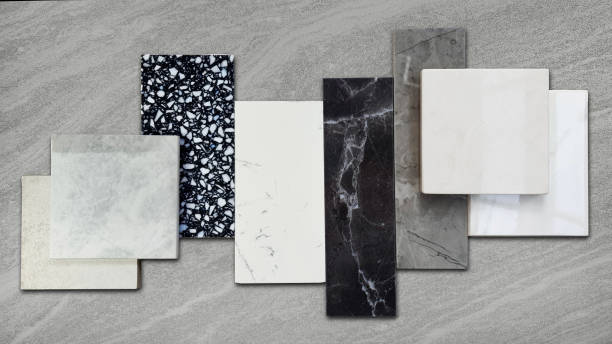 istock set of interior premium stone material samples including black marble, grey artificial stone, terrazzo tiles placed on grey travertine stone floor. countertop or tabletop furnishing material samples. 1492667340