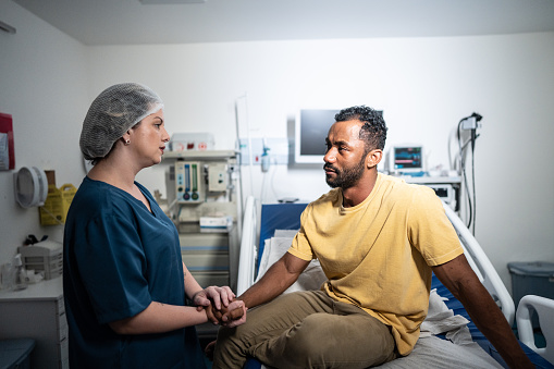 Doctor talking to patient in the hospital