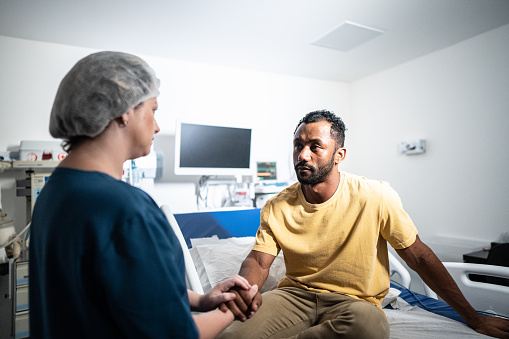 Doctor talking to patient in the hospital