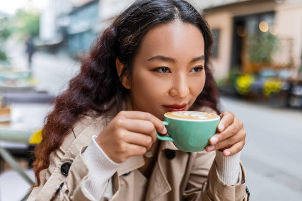 istock Chinese woman drinking coffee in the morning 1492672338