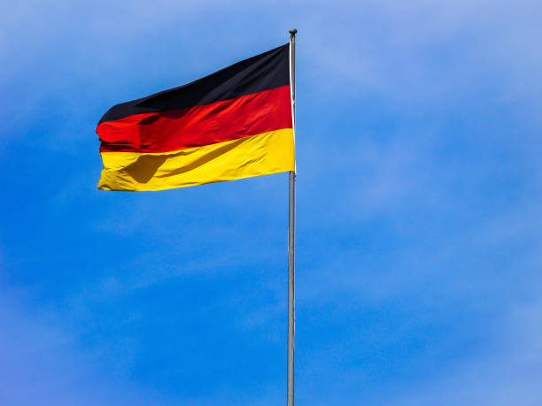 istock Low angle view of flag against blue sky 1492672454