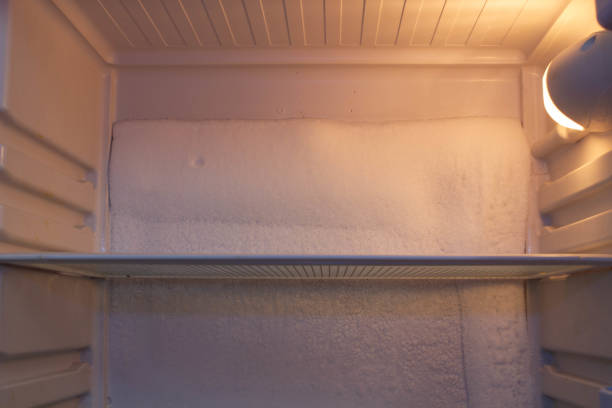 istock Broken refrigerator with snow inside need repairing. Icing on the back wall of the refrigerator. Freezer repaired in a service workshop. Fridge Inside view. Repair of faulty refrigeration equipment 1492672769