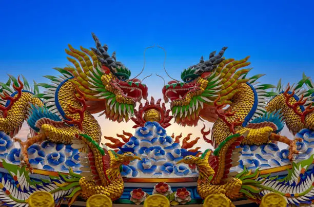 Photo of Colourful multicoloured dragon on top of a  temple in Patong Phuket Thailand. beautiful blue green red of the scale dragons