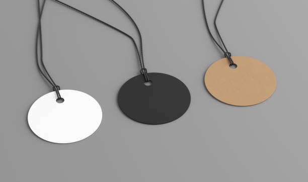 istock White, cardboard, black round tags mockup on gray background. Side view 1492675577