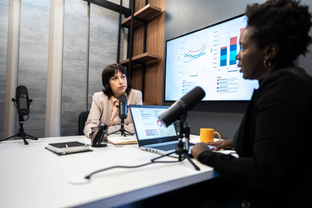Young woman during the recording of a podcast show with a colleague Young woman during the recording of a podcast show with a colleague media occupation stock pictures, royalty-free photos & images