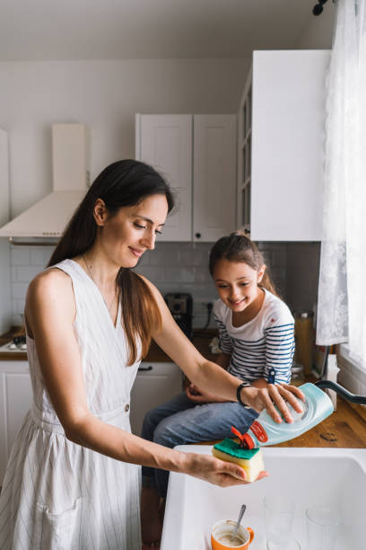 istock Mother and child having fun and bonding while doing dishes in the kitchen 1492677719