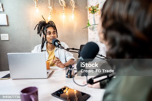istock Young man during the recording of a podcast show with a colleague 1492677735