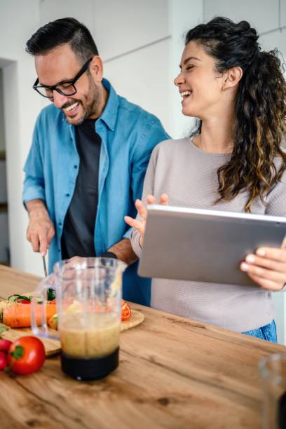 istock Loving couple having fun cooking together at home 1492680917