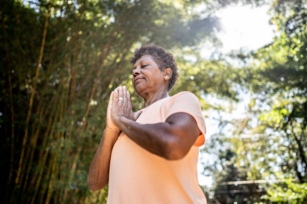 istock Senior woman with hands clasped in the park 1492682003
