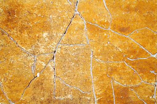 Old cracked orange rustic plaster background texture