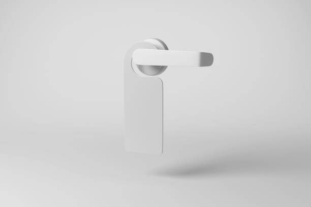 istock White door hanger hanging on a door handle casting shadow on white background in greyscale monochrome. Illustration of the concept of do not disturb sign and privacy 1492685066