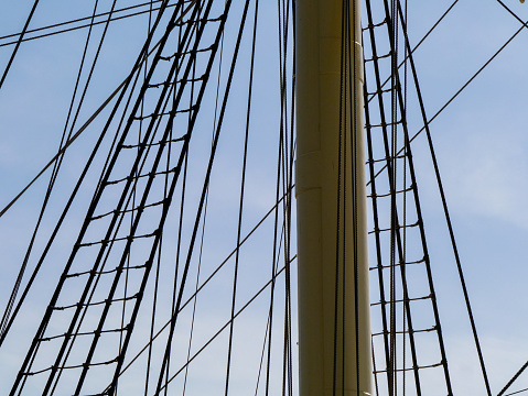 Low angle view of ship mast against blue sky