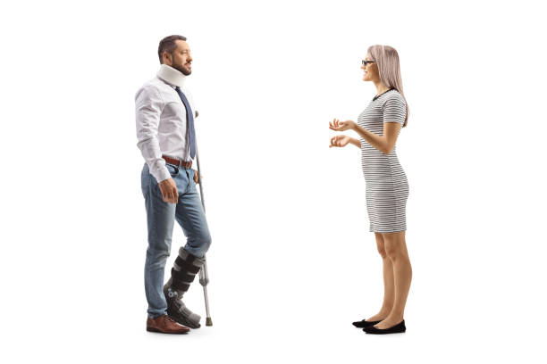 full length profile shot of a young woman talking to an injured man with an orthopedic boot and cervical collar - physical injury men orthopedic equipment isolated on white imagens e fotografias de stock