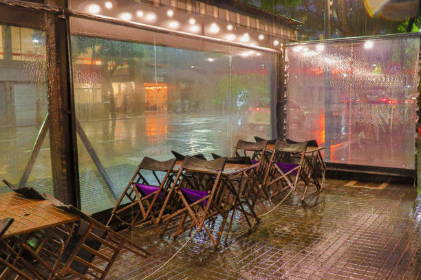 chairs of a restaurant closed for the rain chairs of a restaurant in Buenos Aires closed due to the rain rainy cafe stock pictures, royalty-free photos & images