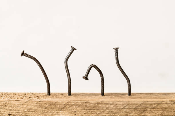 istock Crooked nails in a wooden board. 1492689062