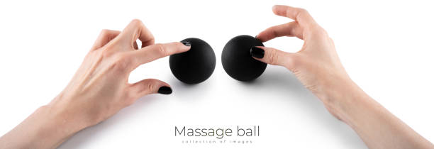 istock Massage black ball in female hand for trigger points isolated on a white background. Concept of myofascial release. 1492689696